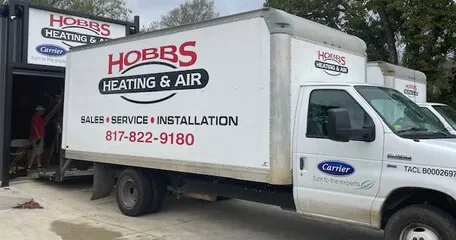 Hobbs Heating and Air technician completing financing paperwork for HVAC installation in Fort Worth, TX